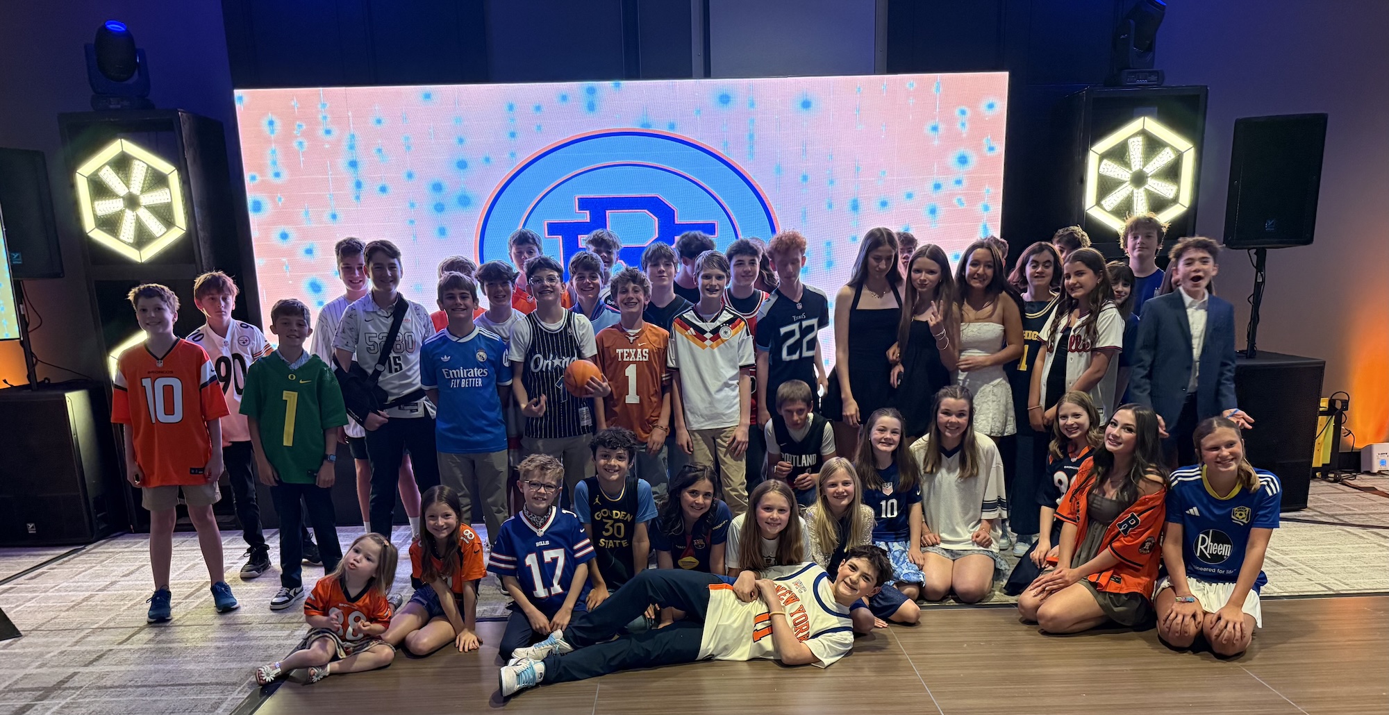 Hank's Basketball Themed Bar Mitzvah Group of kids in sports jerseys at a Bar Mitzvah event.